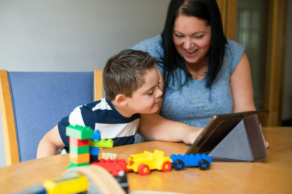 Young boy reading off of a tablet
