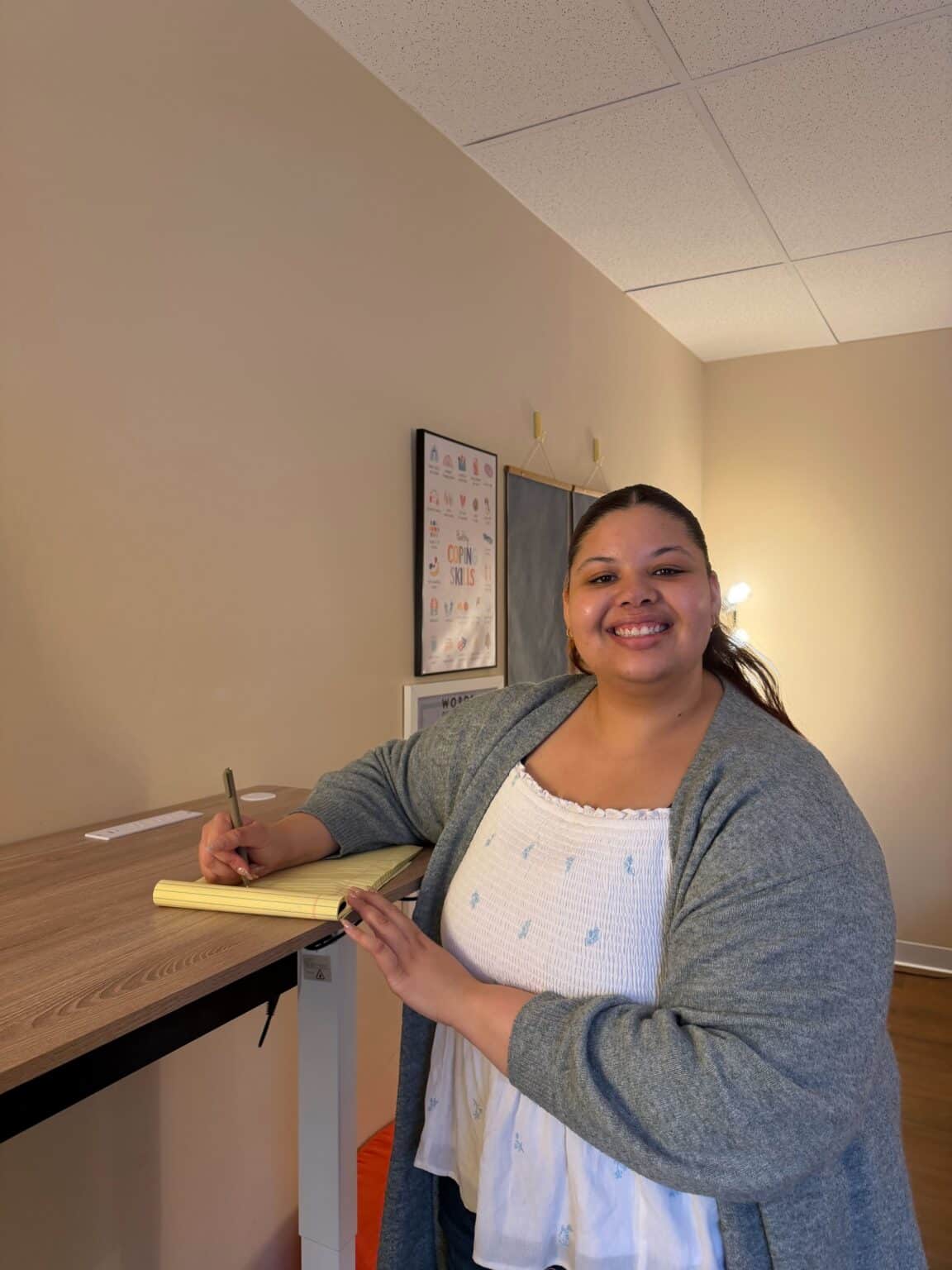 Ashley writing in a notepad