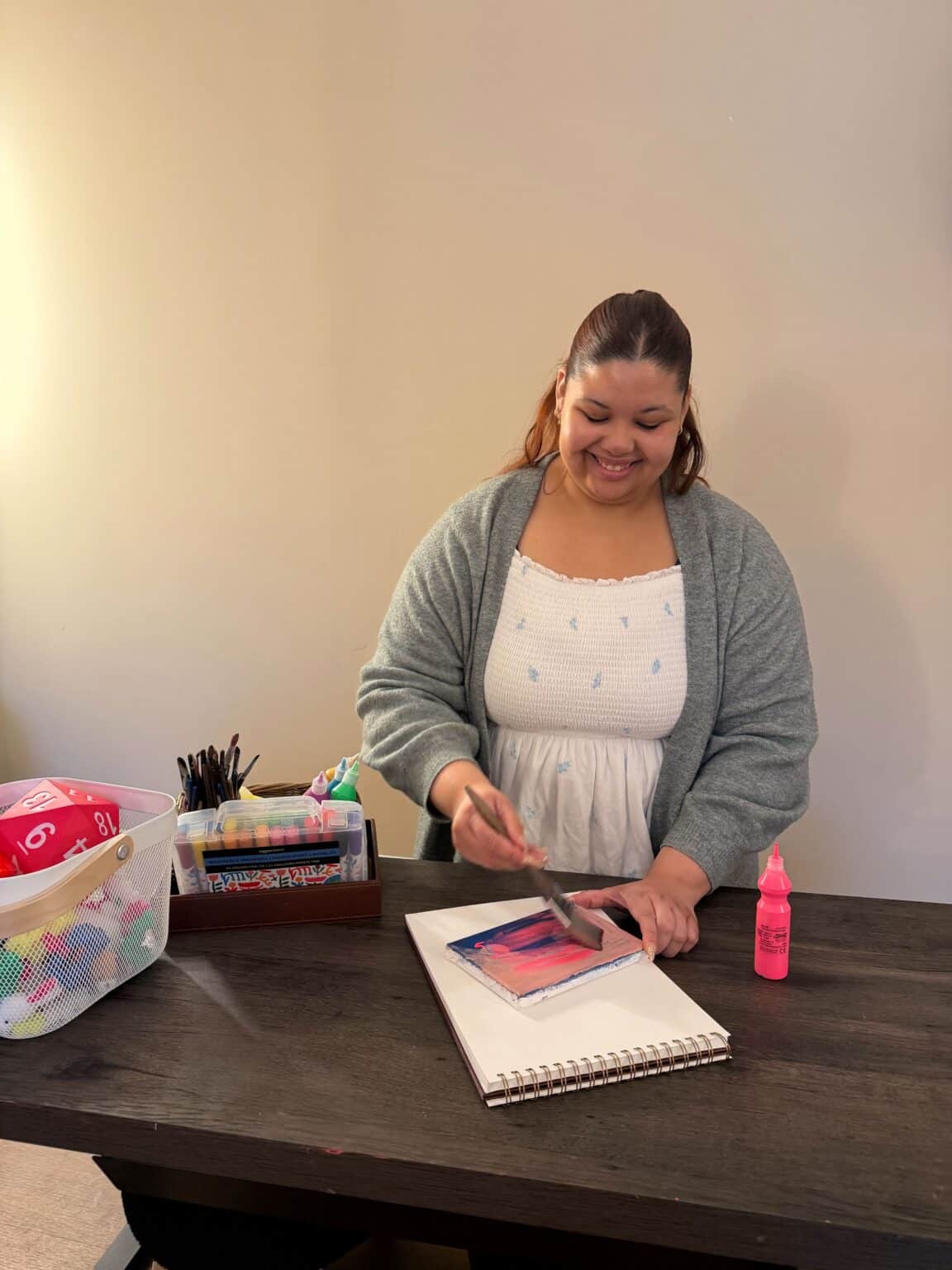 Ashley painting on a canvas