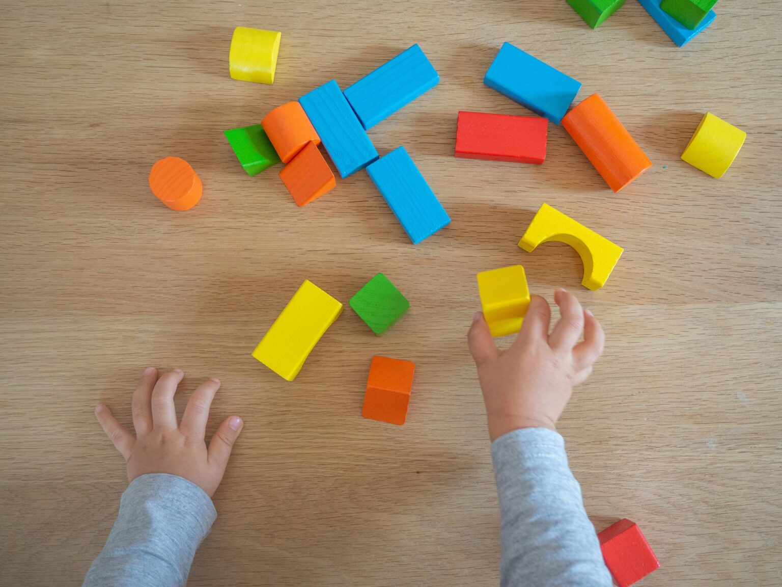 A child playing with blocks on a table
