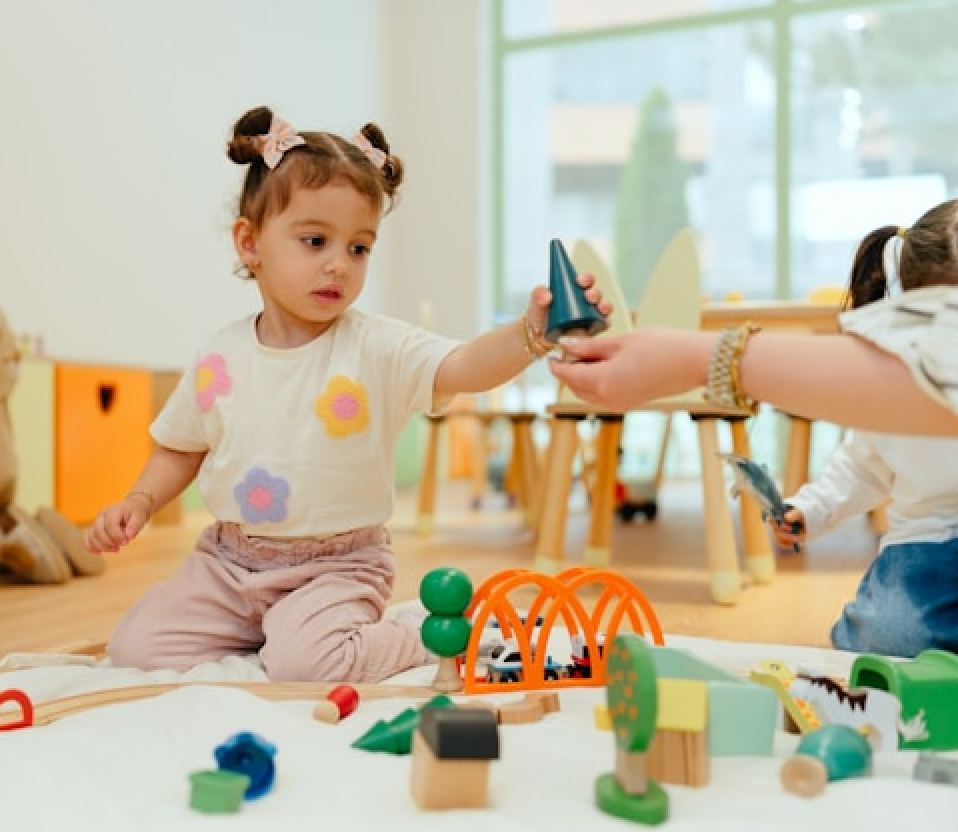 A child is stacking blocks during child therapy session.