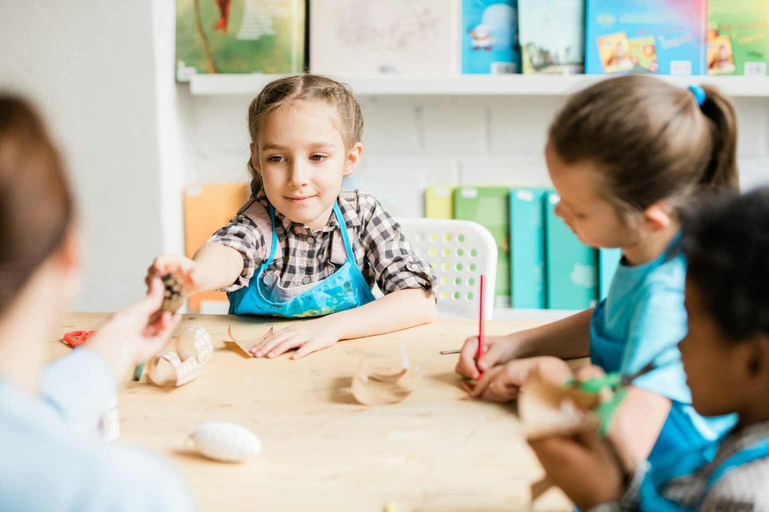 Child is seen doing art activity in a group setting.